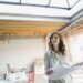 Businesswoman holding blueprints in new office 497325699 5b9ac78146e0fb0025297b7f.jpg
