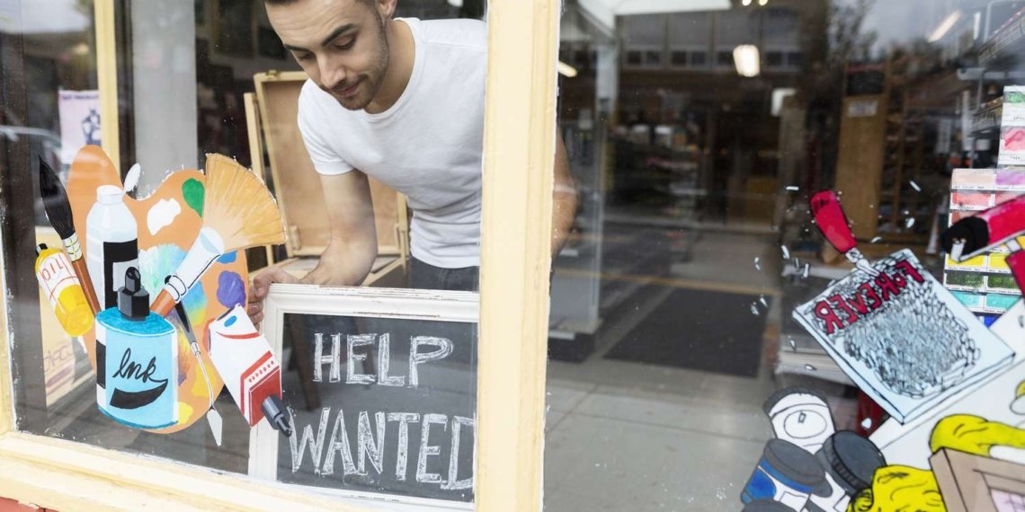 Male business owner placing help wanted sign in art supply shop window 1063781034 a98a24e42bc943e9872ccbe9f4328fa0.jpg